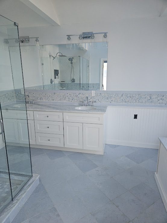 Frameless glass shower with white vanity