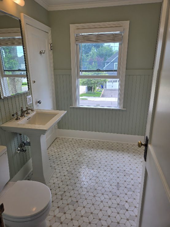 Classic bathroom with pedestal sink and mosaic floor