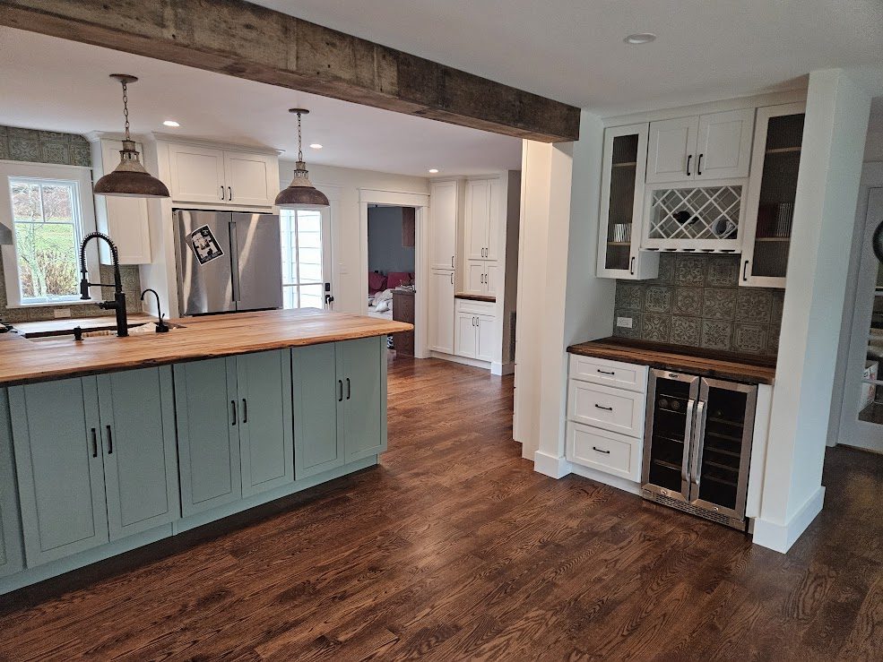White kitchen with sage island and butcher block top