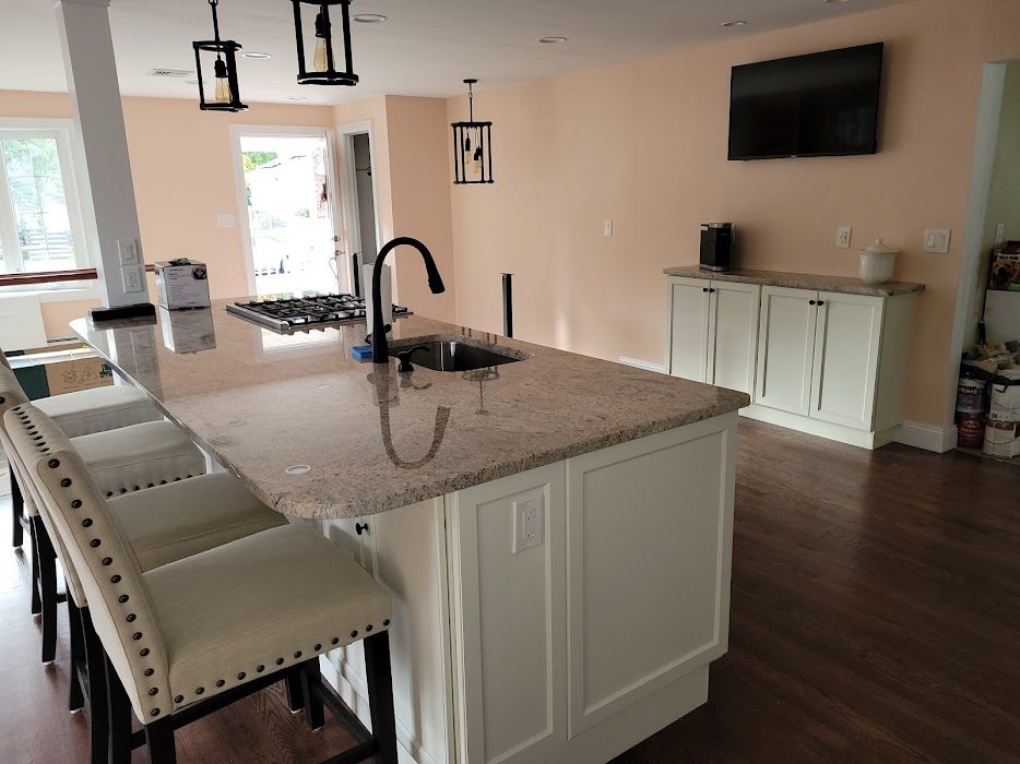 White kitchen with large quartz island and bar seating